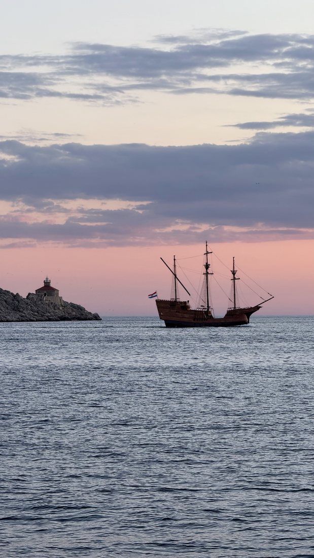 A tall ship sailing at sunset on the Adriatic