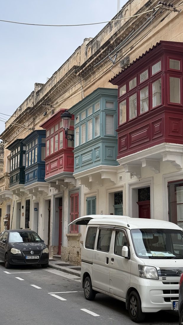 Colorful enclosed wooden balconies on a Maltese street